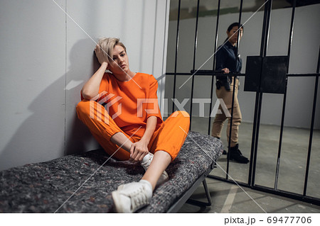 A young pretty blonde prisoner in a general regime prison is sitting in a solitary cell 69477706