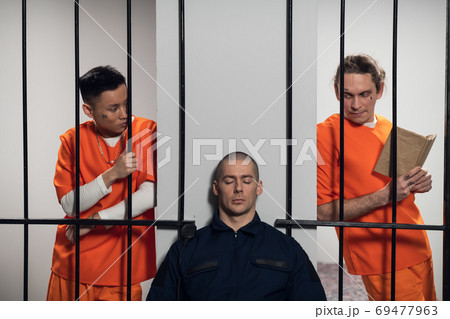 Two prisoners plan to attack a uniformed guard to escape from a maximum security prison 69477963