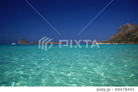 Amazing idyllic view of shiny turquoise sea water, of rocky coast, horizon, bright blue sky. Paradise holidays on ocean Amazing idyllic view of shiny turquoise sea water, of rocky coast, horizon, bright blue sky. Paradise holidays on ocean 69478445