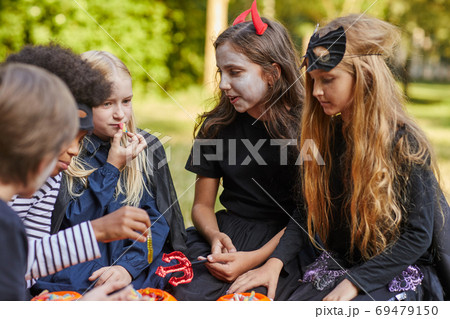Children Eating Candy on Halloween 69479150