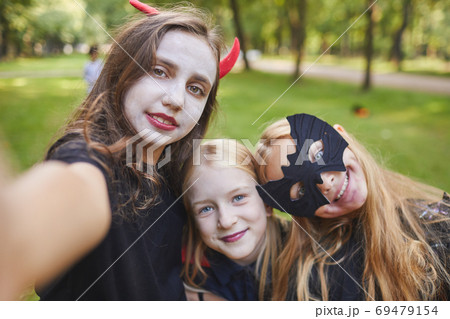 Teenage Girls Taking Selfie on Halloween 69479154