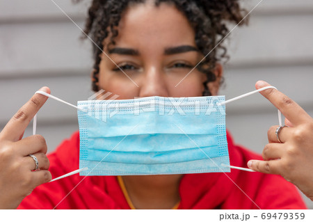 African American female young woman holding face mask COVID-19 Pandemic African American female young woman holding face mask COVID-19 Pandemic 69479359