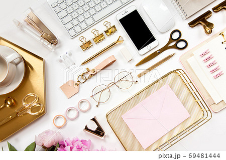Neatly arranged office stationery with modern gadgets, devices, coffee and flowers on white desk. Neatly arranged office stationery with modern gadgets, devices, coffee and flowers on white desk. 69481444