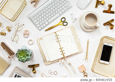 Neatly arranged office stationery with modern gadgets, devices, coffee and flowers on white desk. Neatly arranged office stationery with modern gadgets, devices, coffee and flowers on white desk. 69481450
