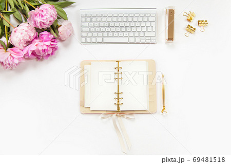 Neatly arranged office stationery with modern gadgets, devices, coffee and flowers on white desk. Neatly arranged office stationery with modern gadgets, devices, coffee and flowers on white desk. 69481518