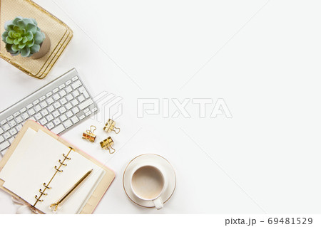 Top view of stylish office desk accessories with keyboard and cup of cappuccino on the gold tray. Top view of stylish office desk accessories with keyboard and cup of cappuccino on the gold tray. 69481529