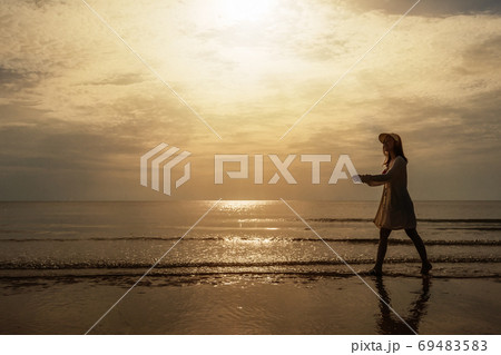 cheerful woman in bikini walking on sea beach 69483583