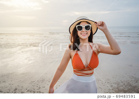 cheerful woman in bikini enjoying on sea beach 69483591