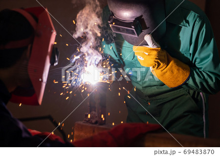 Metal welding steel works using electric arc welding machine Metal welding steel works using electric arc welding machine 69483870