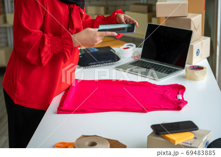 Online seller works at home office and packs shipping delivery box to customer. 69483885