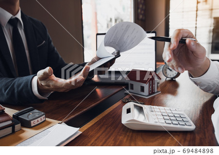 Business people home sales broker is using a pen pointing to the 69484898
