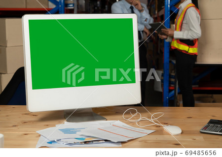 Computer with green screen display in warehouse storage room Computer with green screen display in warehouse storage room 69485656
