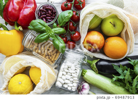 Fresh fruits and vegetables in eco cotton bags on table  69487913