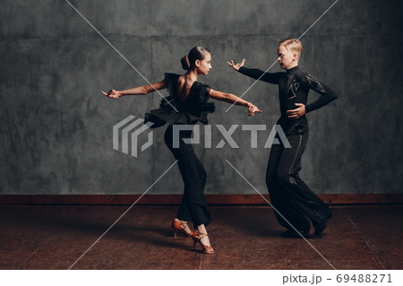 Young couple dancing in ballroom dance cha cha cha. Young couple dancing in ballroom dance cha cha cha. 69488271