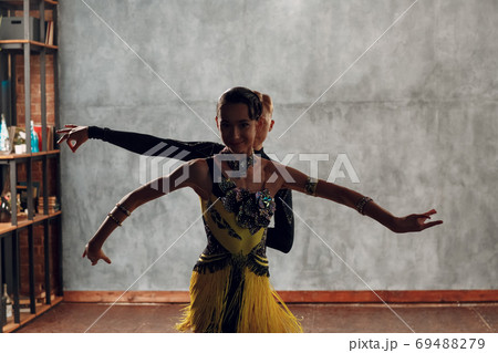 Young couple dancers dancing ballroom dance cha-cha-cha. 69488279