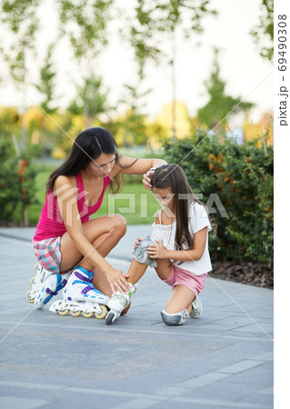 little child girl falled down while rolling with her mother little child girl falled down while rolling with her mother 69490308