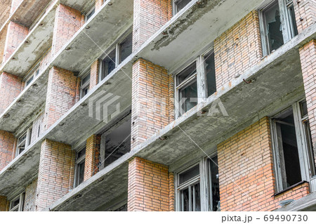 Facade of an old abandoned apartment building 69490730