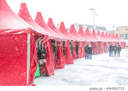 Christmas tents at the downtown fairground during a blizzard Christmas tents at the downtown fairground during a blizzard 69490751