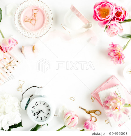 Fashion blog pink style desk with accessories, tulip flowers, scissors, coffee cup on white background. Flat lay. Top view. Fashion blog pink style desk with accessories, tulip flowers, scissors, coffee cup on white background. Flat lay. Top view. 69496003