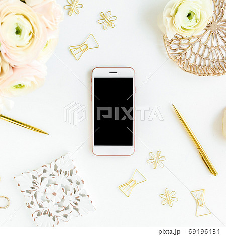 Workspace with diary, gold accessories, ranunculus flowers on white background. Home office desk. Top view feminine background. Flat lay, top view. 69496434