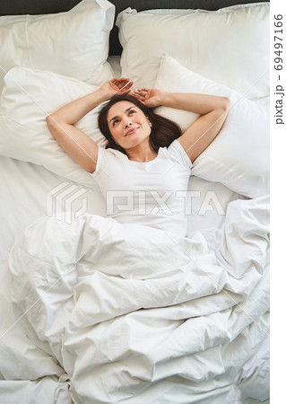 Dark-haired lady gazing up at the ceiling Dark-haired lady gazing up at the ceiling 69497166