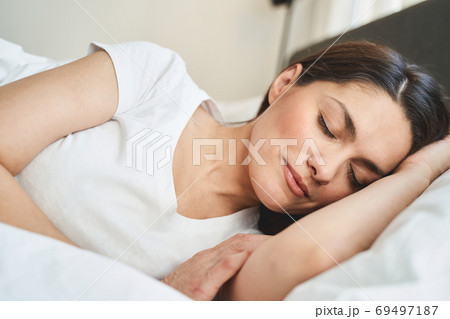 Serene lady dozing off in her bedroom Serene lady dozing off in her bedroom 69497187
