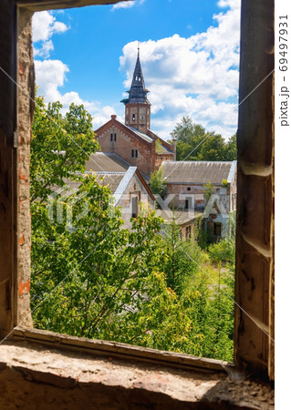 Old abandoned Catholic Church overgrown with greenery 69497931