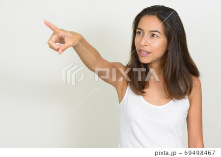 Portrait of beautiful multi ethnic woman pointing finger Portrait of beautiful multi ethnic woman pointing finger 69498467
