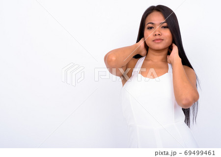 Portrait of young Asian businesswoman with hands behind head 69499461