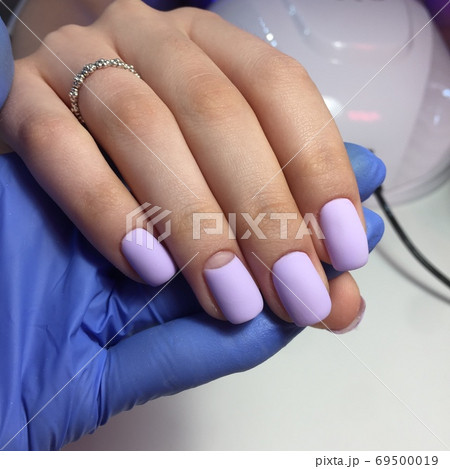 blue female manicure on nails close up 69500019