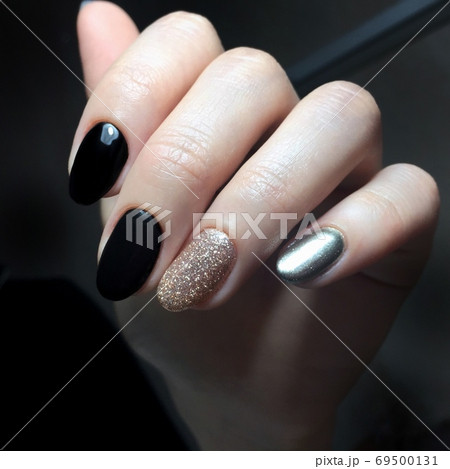 Black female manicure on the nails of a woman Black female manicure on the nails of a woman 69500131