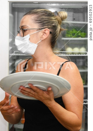 Young waitress with face protective mask working in restaurant. Coronavirus or Covid-19 concept. 69502915