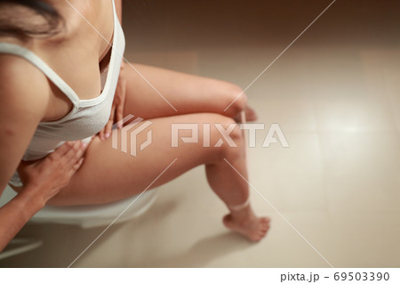 top view portrait of young woman using toilet top view portrait of young woman using toilet 69503390