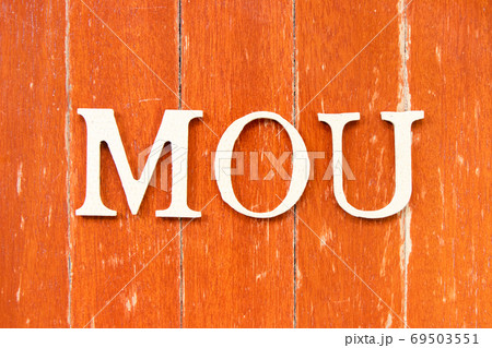 Alphabet letter in word MOU (Abbreviation of memorandum of understanding) on old red color wood plate background Alphabet letter in word MOU (Abbreviation of memorandum of understanding) on old red color wood plate background 69503551