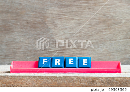 Tile letter on red rack in word free on wood background Tile letter on red rack in word free on wood background 69503566