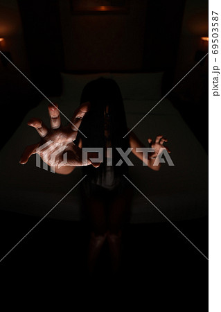 ghost women hand in haunted hotel with dark filter, halloween concept 69503587