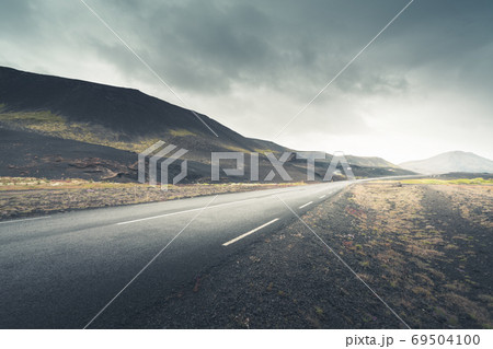 Icelandic landscape with asphalt road 69504100