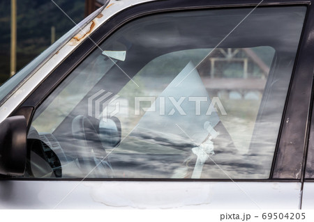 Funny and Sad Picture of a Dog with a Collar sitting on a driver seat Funny and Sad Picture of a Dog with a Collar sitting on a driver seat 69504205