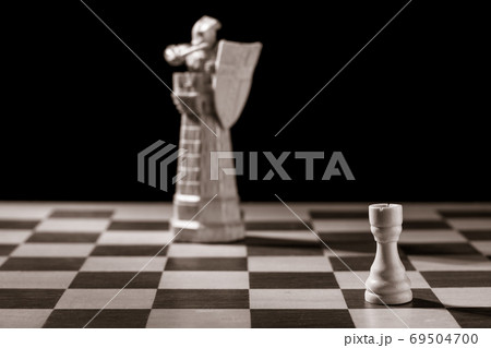 Classic white rook and the same chess piece in the form of medieval figure 69504700