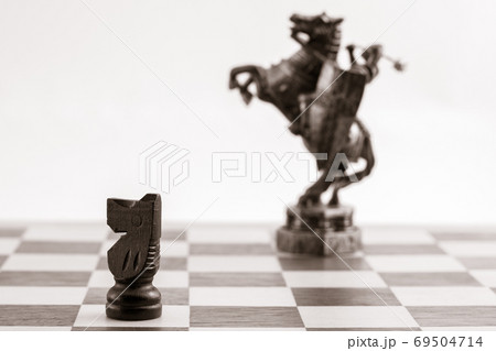 Classic black knight and the same piece in the form of medieval figure Classic black knight and the same piece in the form of medieval figure 69504714