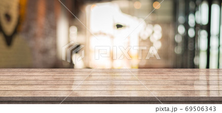 Empty wooden table top with lights bokeh on blur restaurant background 69506343