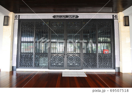 KELANTAN, MALAYSIA -MARCH 30, 2014: Bunut Payung Mosque. New mosque build with local architectural style with influenced of Islamic geometry and Islamic architectural element. KELANTAN, MALAYSIA -MARCH 30, 2014: Bunut Payung Mosque. New mosque build with local architectural style with influenced of Islamic geometry and Islamic architectural element. 69507518