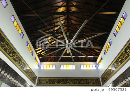 KELANTAN, MALAYSIA -MARCH 30, 2014: Bunut Payung Mosque. New mosque build with local architectural style with influenced of Islamic geometry and Islamic architectural element. KELANTAN, MALAYSIA -MARCH 30, 2014: Bunut Payung Mosque. New mosque build with local architectural style with influenced of Islamic geometry and Islamic architectural element. 69507521
