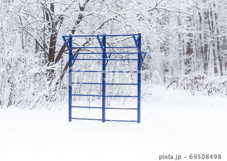 Sports equipment simulators for building muscle mass in the winter park on the street Sports equipment simulators for building muscle mass in the winter park on the street 69508498