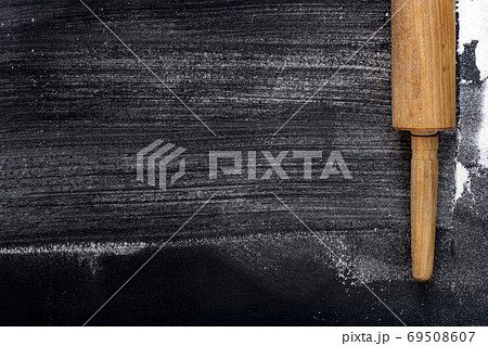 Selective focus. Rolling pin and Wheat Flour on a dark background 69508607