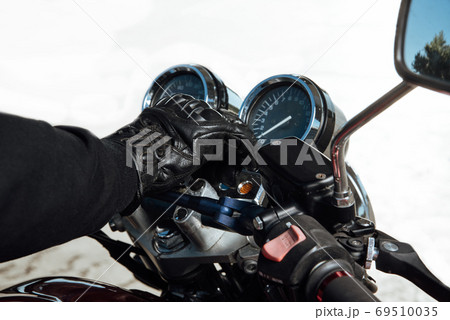 Man rides a motorcycle in the city.Motorcyclist riding a bike during the day on the road Man rides a motorcycle in the city.Motorcyclist riding a bike during the day on the road 69510035