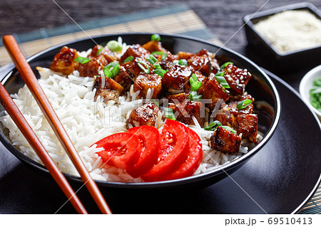 Teriyaki tofu with rice sprinkled by sesame seeds Teriyaki tofu with rice sprinkled by sesame seeds 69510413