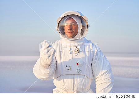 Astronaut in holding mineral crystal Astronaut in holding mineral crystal 69510449