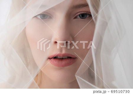 Gorgeous young woman wearing beautiful white veil Gorgeous young woman wearing beautiful white veil 69510730