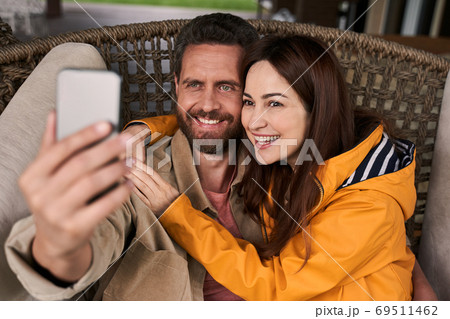 Happy loving couple hugging and making selfie outdoors 69511462